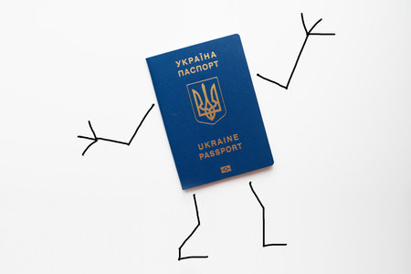 Ukraine passport with painted hands and feet shows gesture okの写真素材