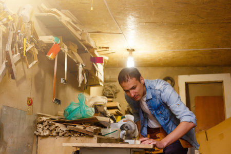 Carpenter works in a workshop for the production of vintage furniture