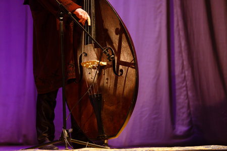 A person on a stage in front of a curtainの写真素材