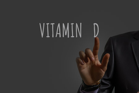 businessmans hand shows vitamin dの写真素材