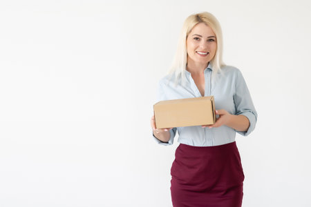 picture of attractive businesswoman delivering cardboard boxの写真素材