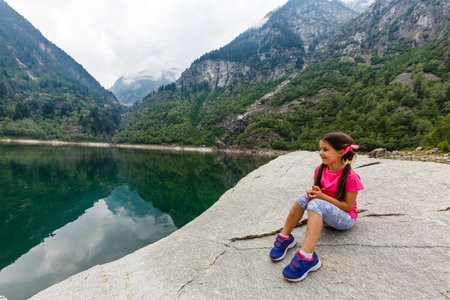 alpine high mountain lake, coniferous woods are reflected in the water, Antrona valley Campliccioli lake, Italy Piedmontの写真素材