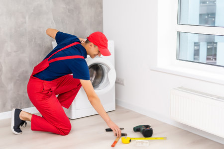 Master repairs the broken washing machineの写真素材
