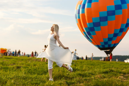 A tourist woman enjoying wonderful view of the balloons. Happy Travel conceptの写真素材