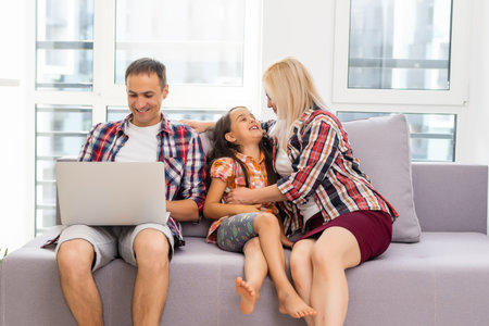 Happy family surf on the internetの写真素材