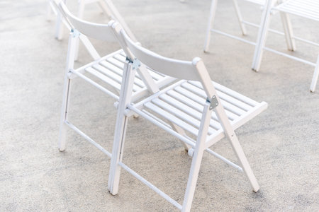 Rows of empty metal chair seats installed for some business event or performance,festivalの写真素材