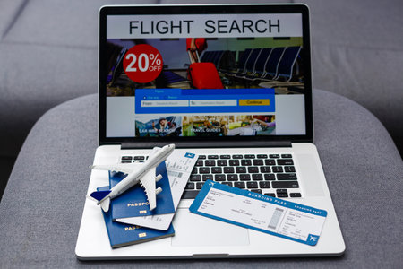 Boarding pass, passport and toy aircraft on desk top viewの写真素材