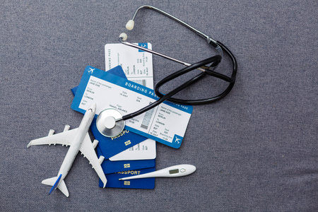 Coronavirus and travel concept. The concept of restrictions for tourism. Passport, thermomether and protective medical masks.の写真素材