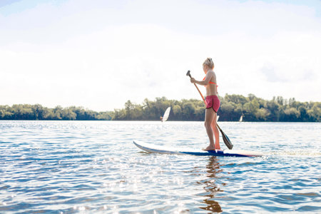 Action Shot of Young Woman on Paddle Board