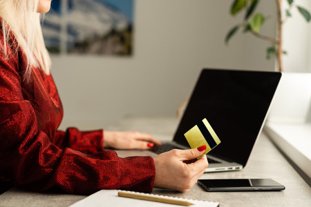 Beautiful young woman working on her laptop in her office.の写真素材