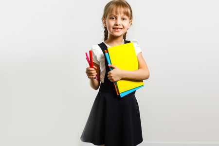 little blond school girl with backpack bag portrait isolated on white background