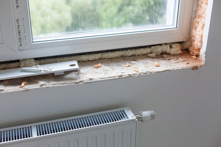 Repair in the slopes of the window. The process of applying a layer of plaster on the sides of the window.の写真素材