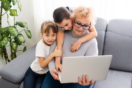 Grandmother with granddaughter use laptop learn counting together home