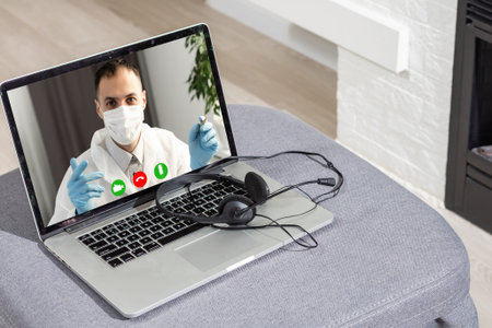 Doctor Having Video Conference On Laptop With Colleagues