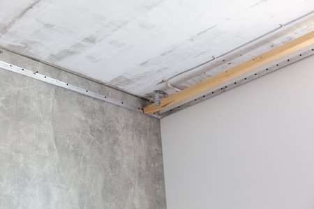 repairmen install stretch ceiling made of pvc vinyl film using a gas heat gunの写真素材