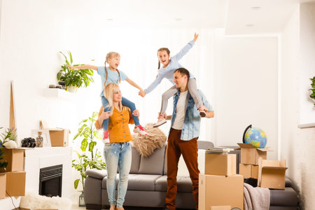 Happy family moving home with boxes around