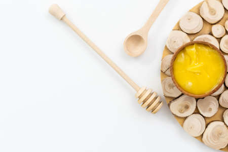 Bowl of honey on white background. Symbol of healthy living and natural medicine. Aromatic and tasty.の写真素材