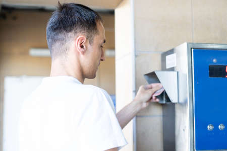 Young man spraying his car cleanの写真素材