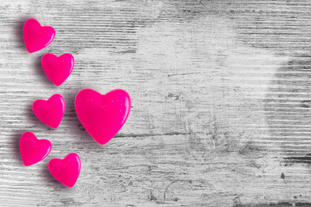 Valentines day background with red hearts on wooden planks
