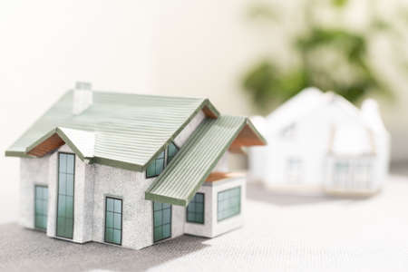 Volumetric project of house. Layout of a house with an open roof. Miniature layout of a cottage top view. Building model as a symbol of architectural business. Design in architectural bureau.の写真素材