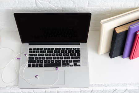 Working desk. Open laptop, books, officeの写真素材