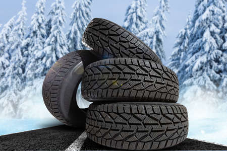 four winter tires on a winter backgroundの写真素材