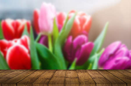 Empty top wooden table and flower blurred background. Can use for product displayの写真素材