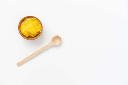 Golden honey in the wooden bowl with dipperの写真素材