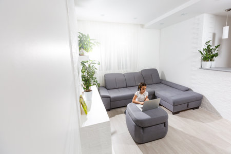 A young girl is attending online school or classes. Study in lock down as Schools closedの写真素材