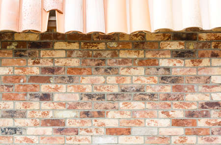 red brick wall house roof details closeupの写真素材