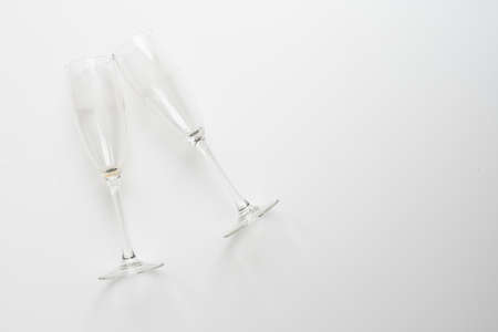 Two elegant champagne glasses on white backgroundの写真素材