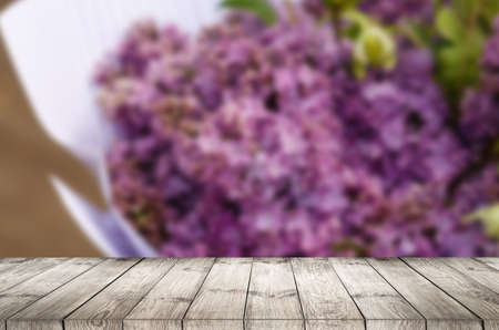 Empty top wooden table and flower blurred background. Can use for product displayの写真素材