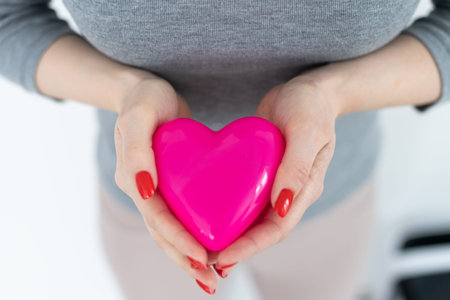 Valentines Day. Beautiful smiling woman with a gift in the form of heart in his hands