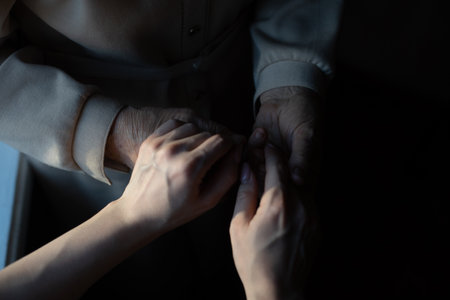 very elderly great-grandmother and granddaughter hold handsの写真素材