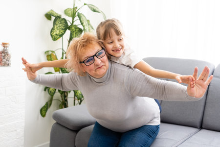 Cheerful woman taking care of her grandmother At Home.