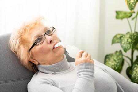 Senior woman making inhalation, elderly woman and nebulizer