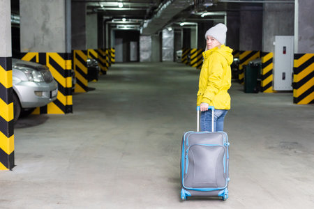 girl with bag in the parking at the airportの写真素材