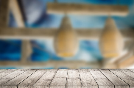 Empty wooden table with garden bokeh for a catering or food background with a country outdoor theme.