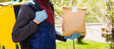 Diverse of paper containers for takeaway food. Delivery man is carryingの写真素材