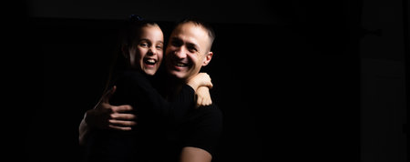 father and daughter on black backgroundの写真素材