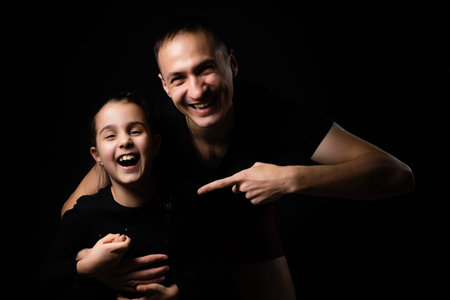 father and daughter on black backgroundの写真素材