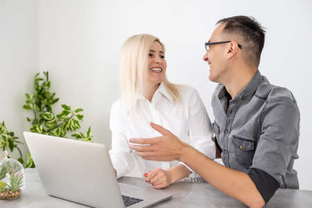 woman and man with laptop, Business partners working at the office on a computerの写真素材