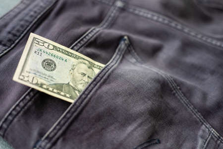 American dollar bills in jeans pocket backgroundの写真素材