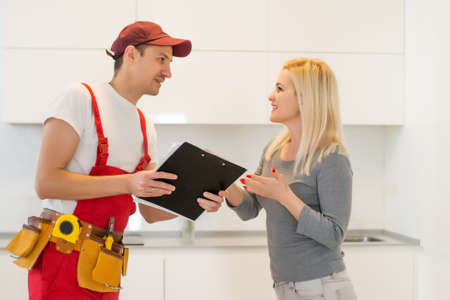 a washing machine repair service with female customerの写真素材