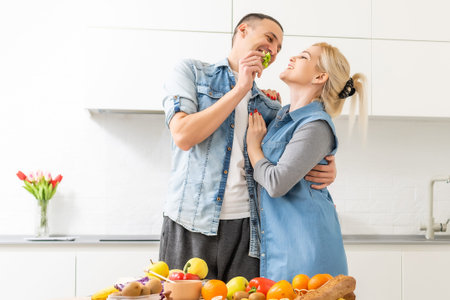 couple cooking healthy food in kitchen lifestyle meal preparation