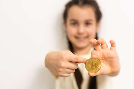 Little girl holding bitcoin crypto currencyの写真素材