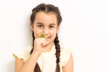 Little girl holding bitcoin crypto currencyの写真素材