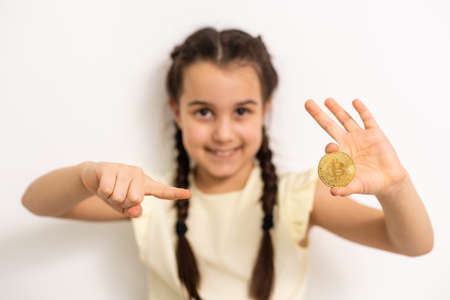 Little girl holding bitcoin crypto currencyの写真素材