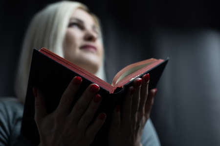A close-up of a christian woman reading the bible.の写真素材