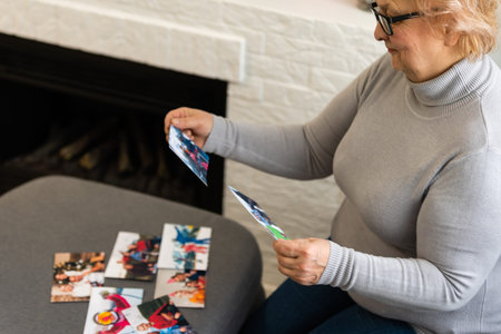 an elderly woman is looking at a photo of her grandchildren